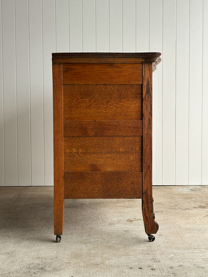 Antique Oak Serpentine Chest with Original Casters and Brass Hardware